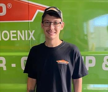 SERVPRO employee in front of green background