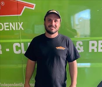 SERVPRO employee in front of green background