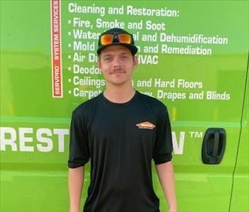 SERVPRO employee in front of green background